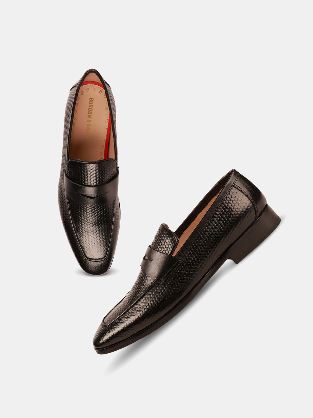 Black formal loafers for men with a textured leather finish and slip-on design — with white backkground