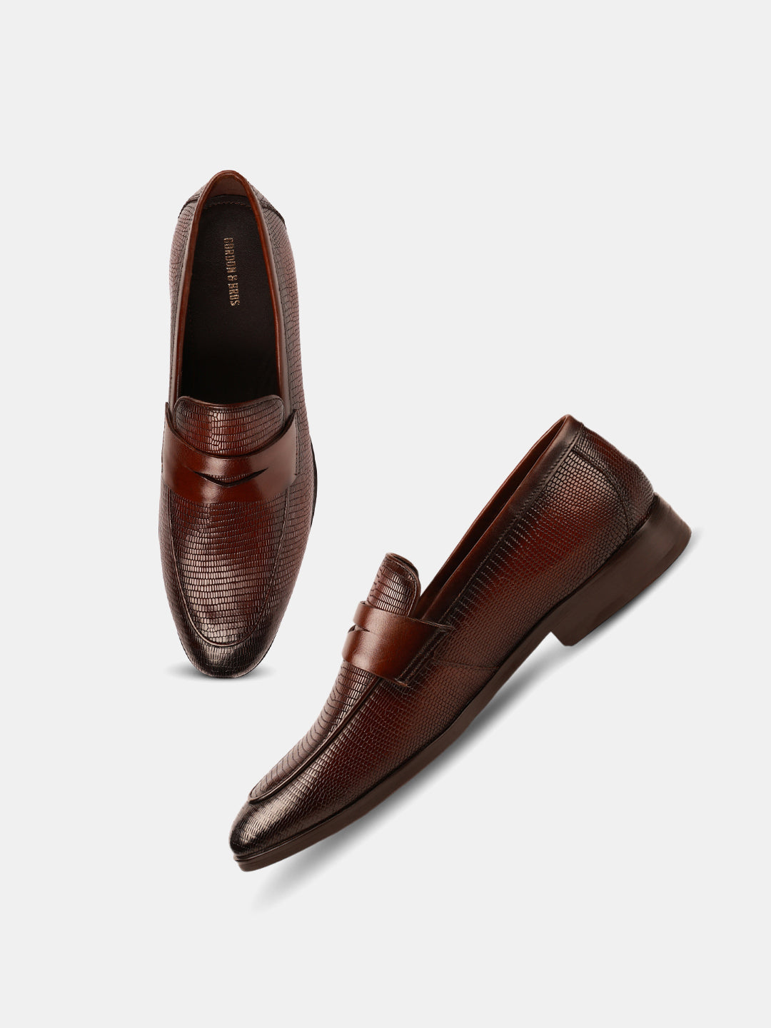 Brown textured loafers for men with a smooth leather finish and slip-on design — with white background