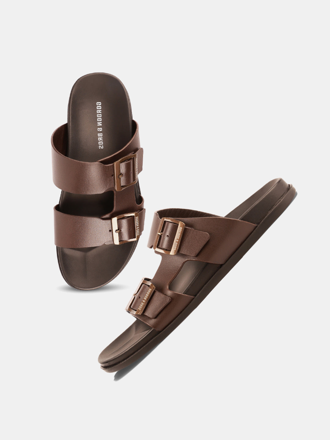 A pair of brown leather sandals with buckle straps.