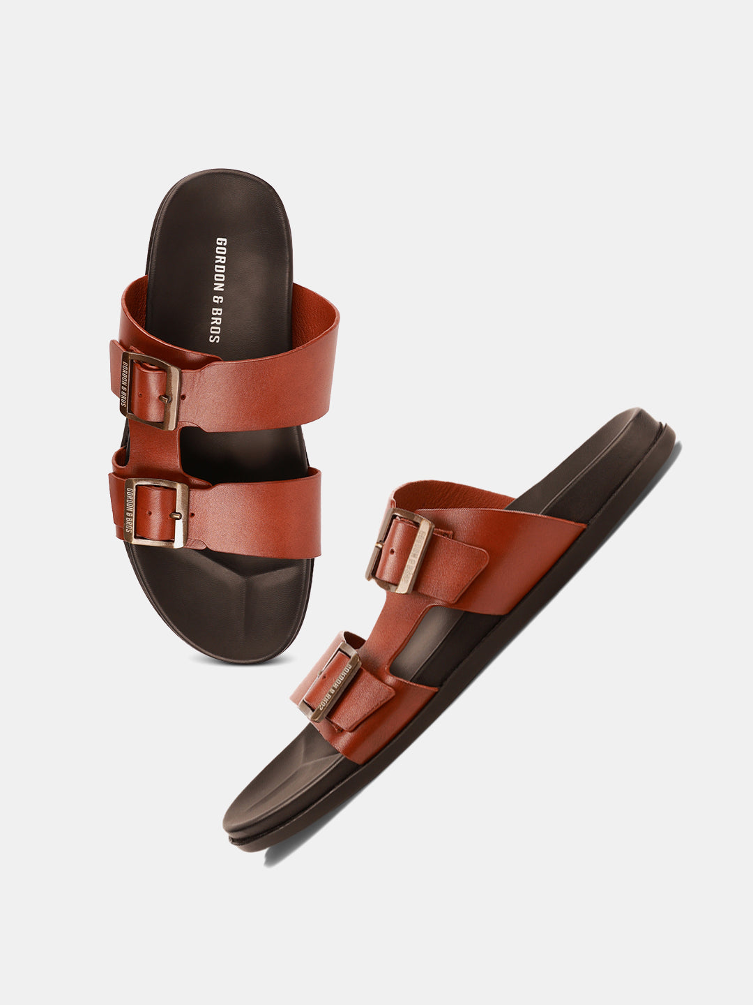 "Men’s tan leather buckle sandals — comfortable and stylish slip-ons for everyday wear.With White Background
