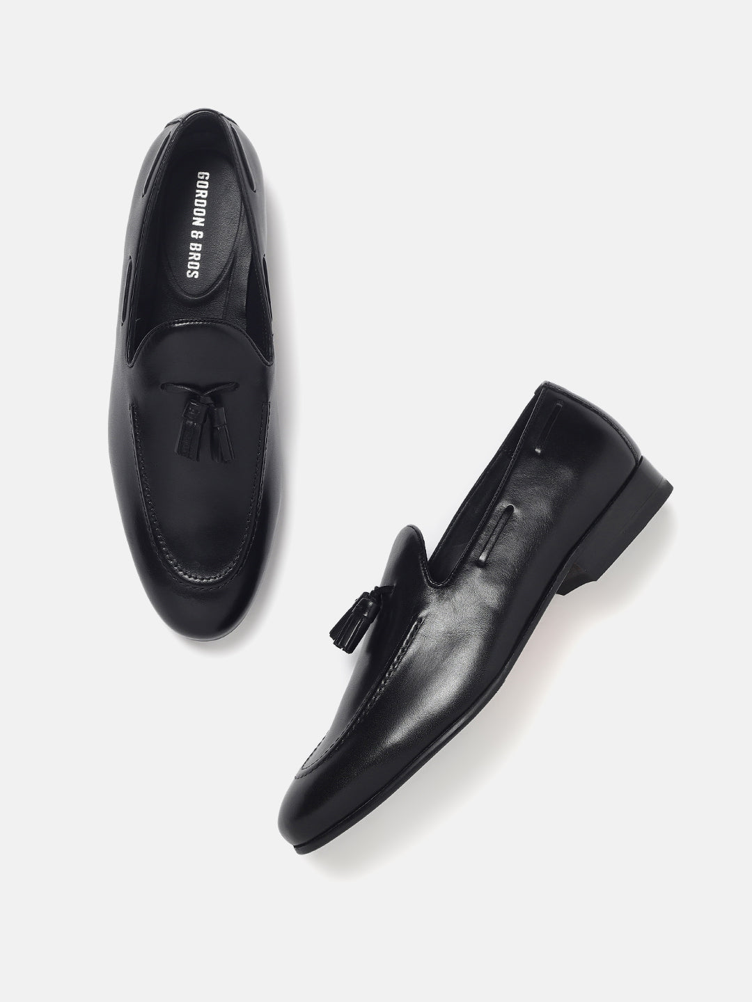"Men’s black leather tassel loafers — sleek slip-on formal shoes with premium finish, With White Background