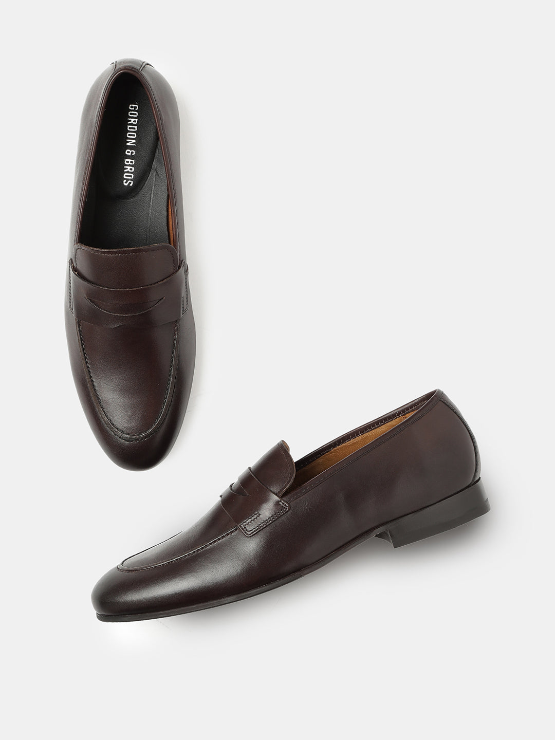 A pair of dark brown leather loafers on a white background.