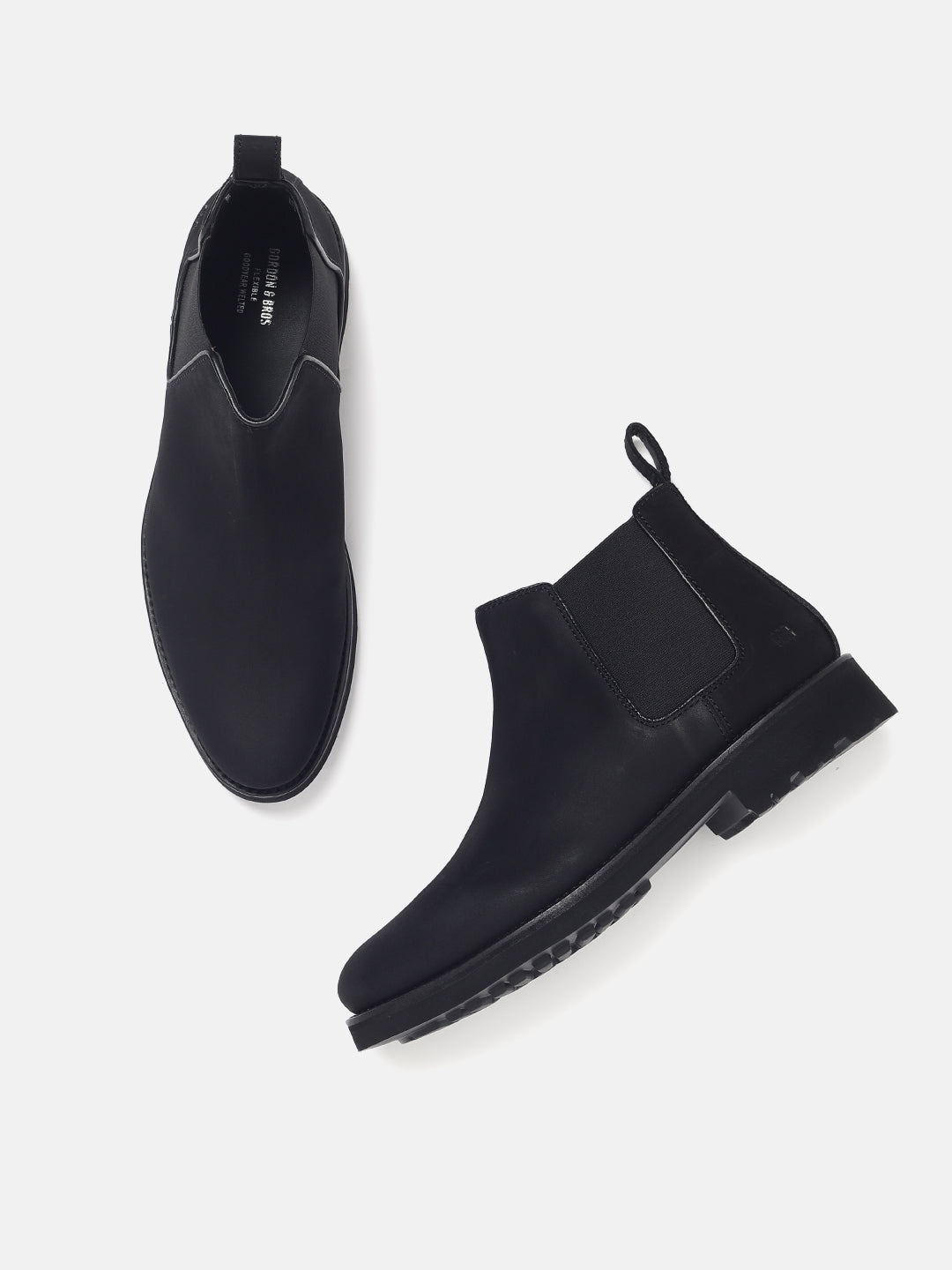 Black matte leather Chelsea boots for men with elastic sides and sturdy sole —with white background