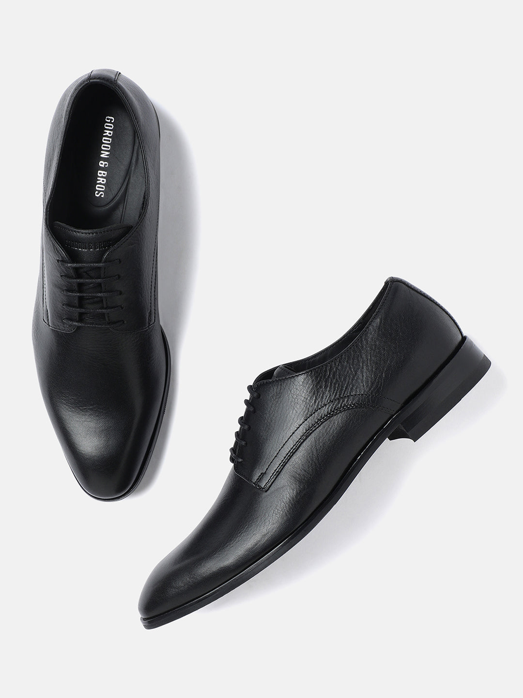 A pair of black leather derby lace-up shoes for men.
