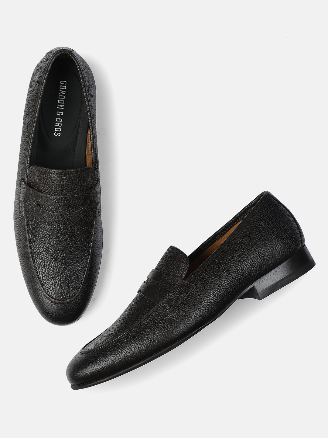 Pair of black loafers on a light gray background