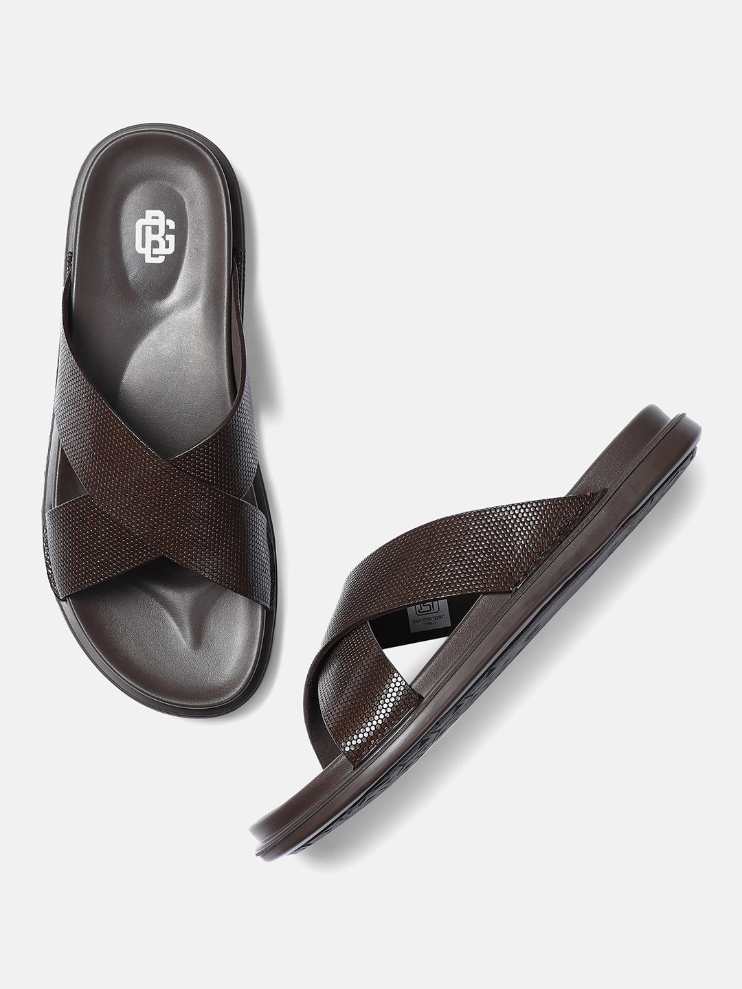A pair of brown premium leather men's sandals with a crisscross strap design.