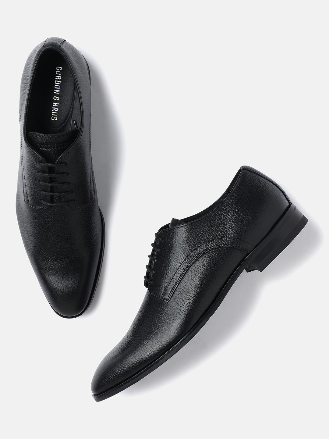 A pair of black men's derby lace-up shoes by GORDON & BROS, displayed against a white background.