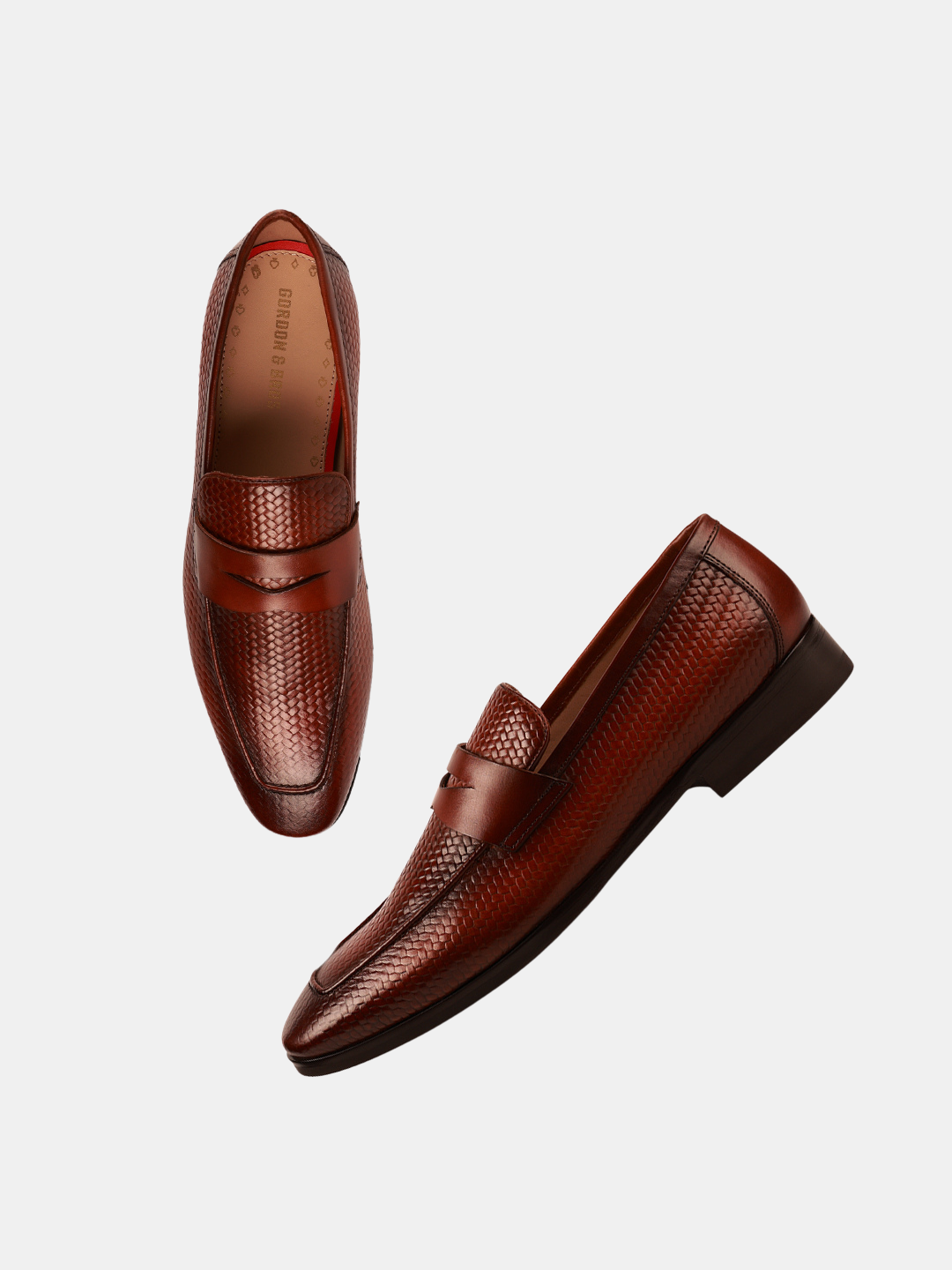 A pair of brown leather loafers isolated on a white background