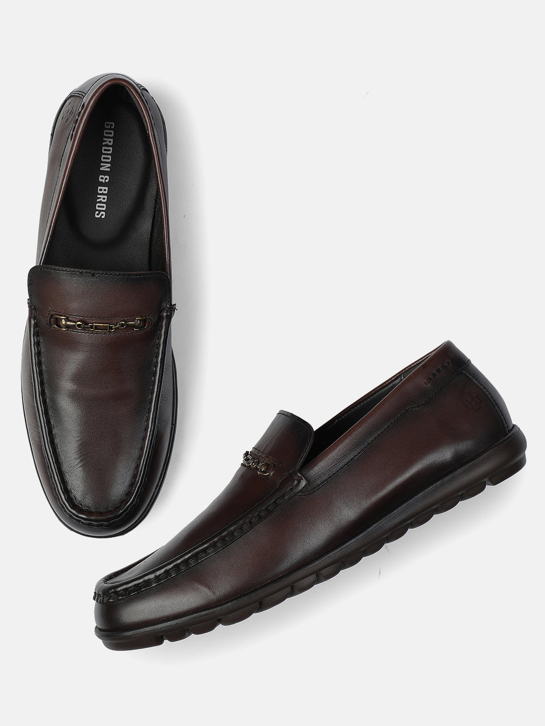 Pair of brown loafers on a white background