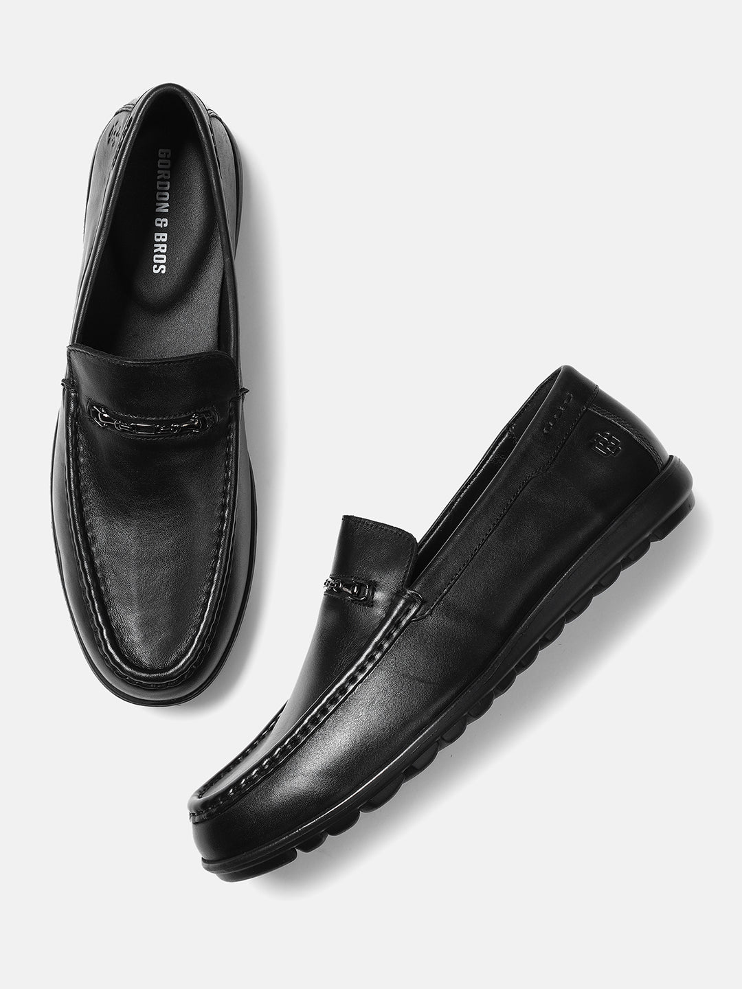 A pair of black men's leather loafers with a cap toe style and visible stitching details.