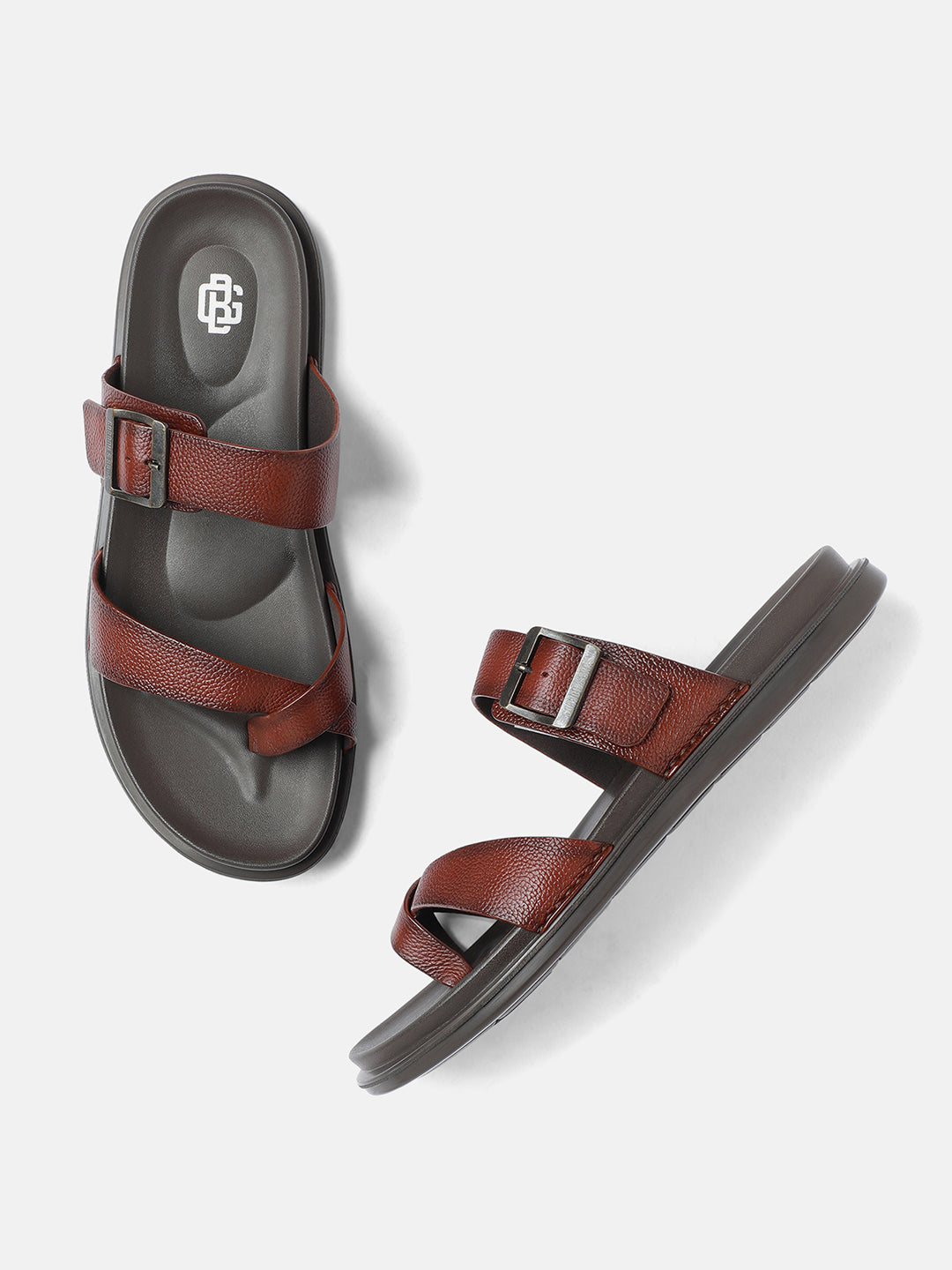 A pair of tan men's sandals with adjustable straps and flat sole, displayed against a white background.