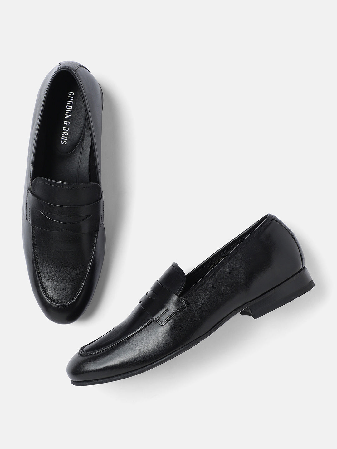 A pair of plain black men's loafers by GORDON & BROS, crafted from premium leather.