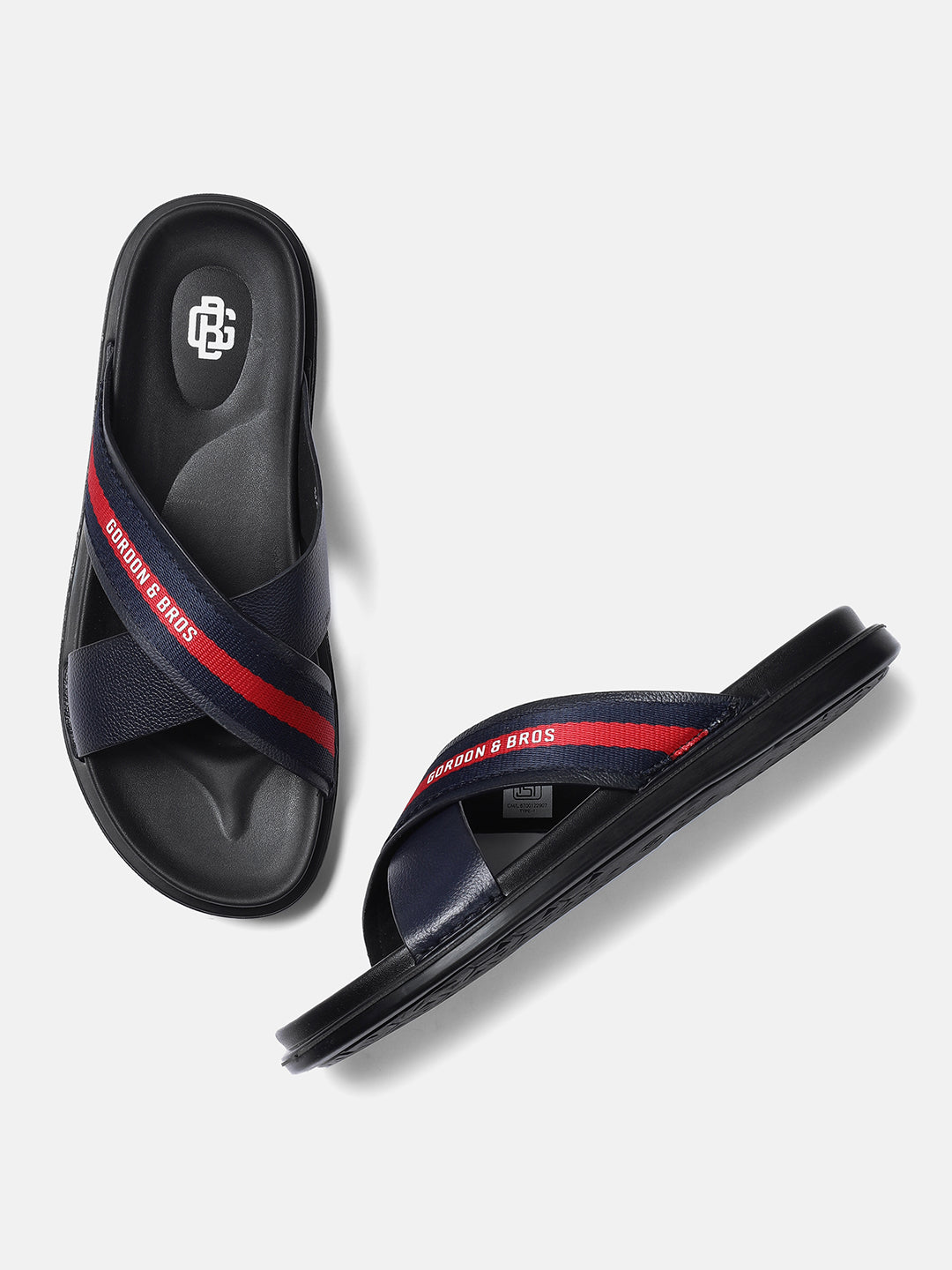 A pair of navy men's sandals with red stripes and a black buckle.
