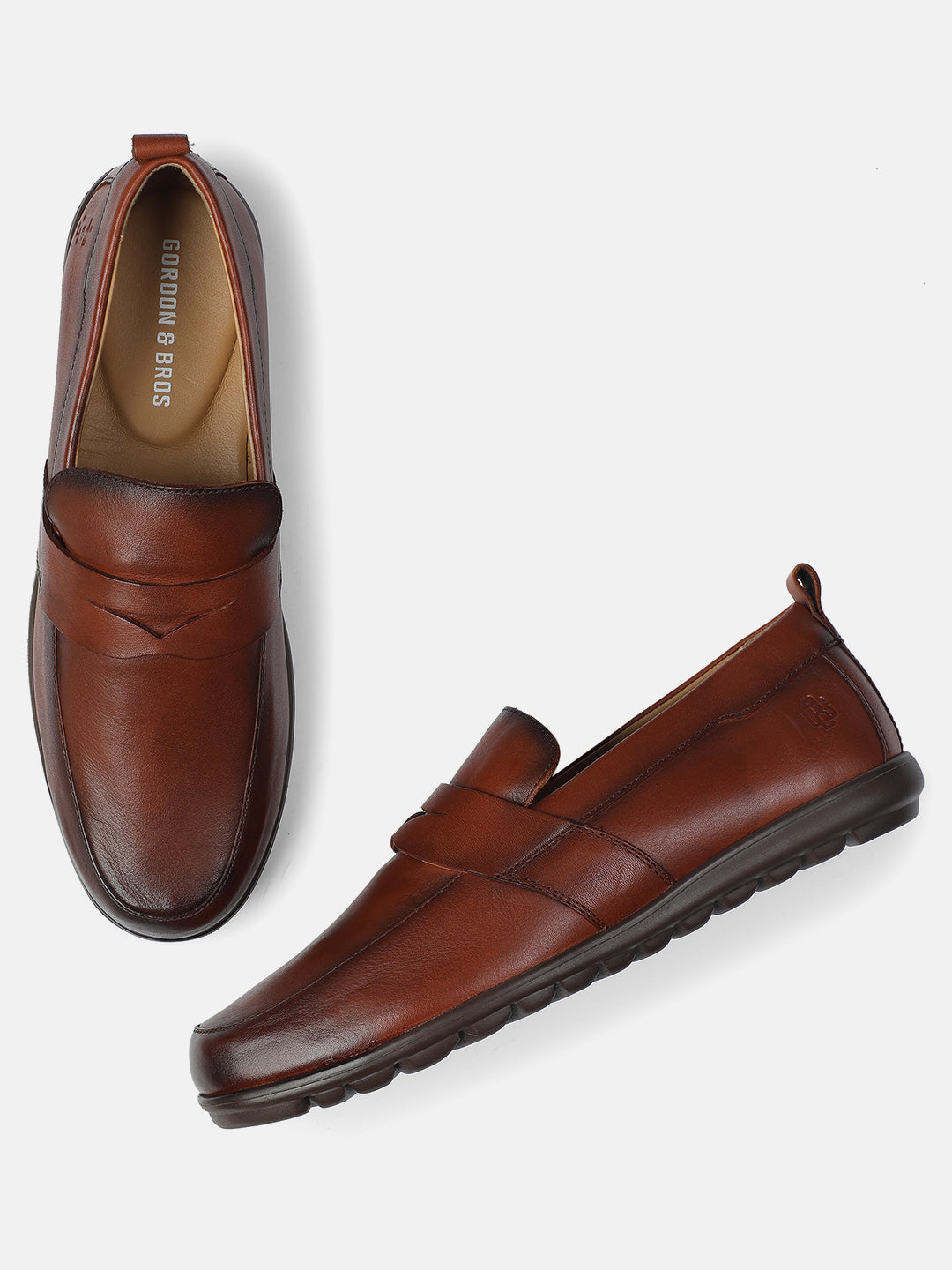 Men’s tan leather loafers with cushioned sole and slip-on design — premium casual and formal footwear, with white background