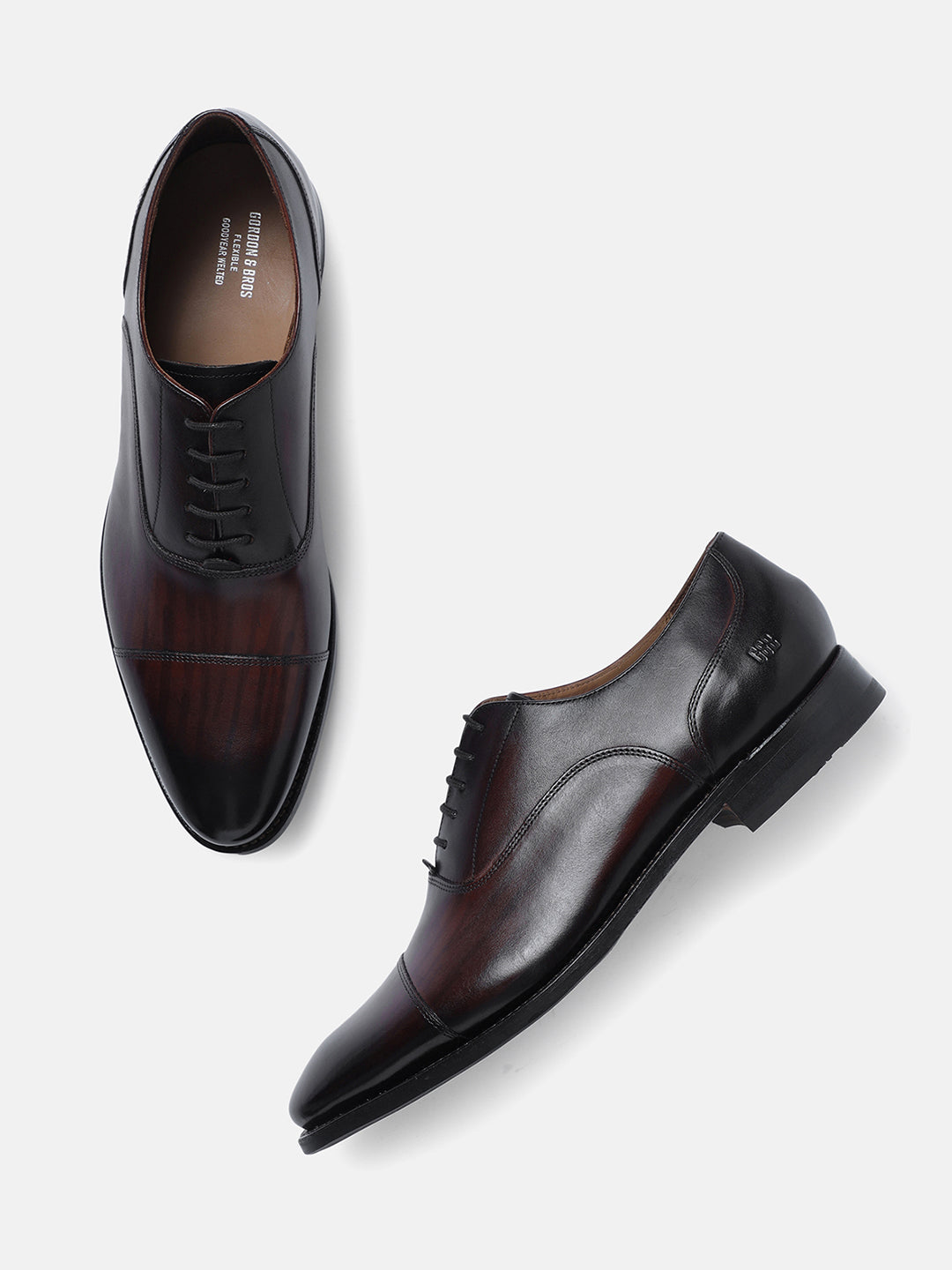 A pair of brown leather toe cap Oxford lace-up shoes displayed against a white background.