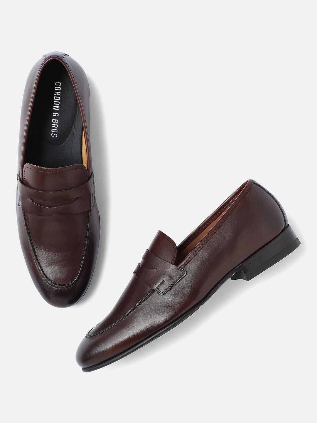 A pair of light brown men's loafers with a sleek design, crafted from premium leather.