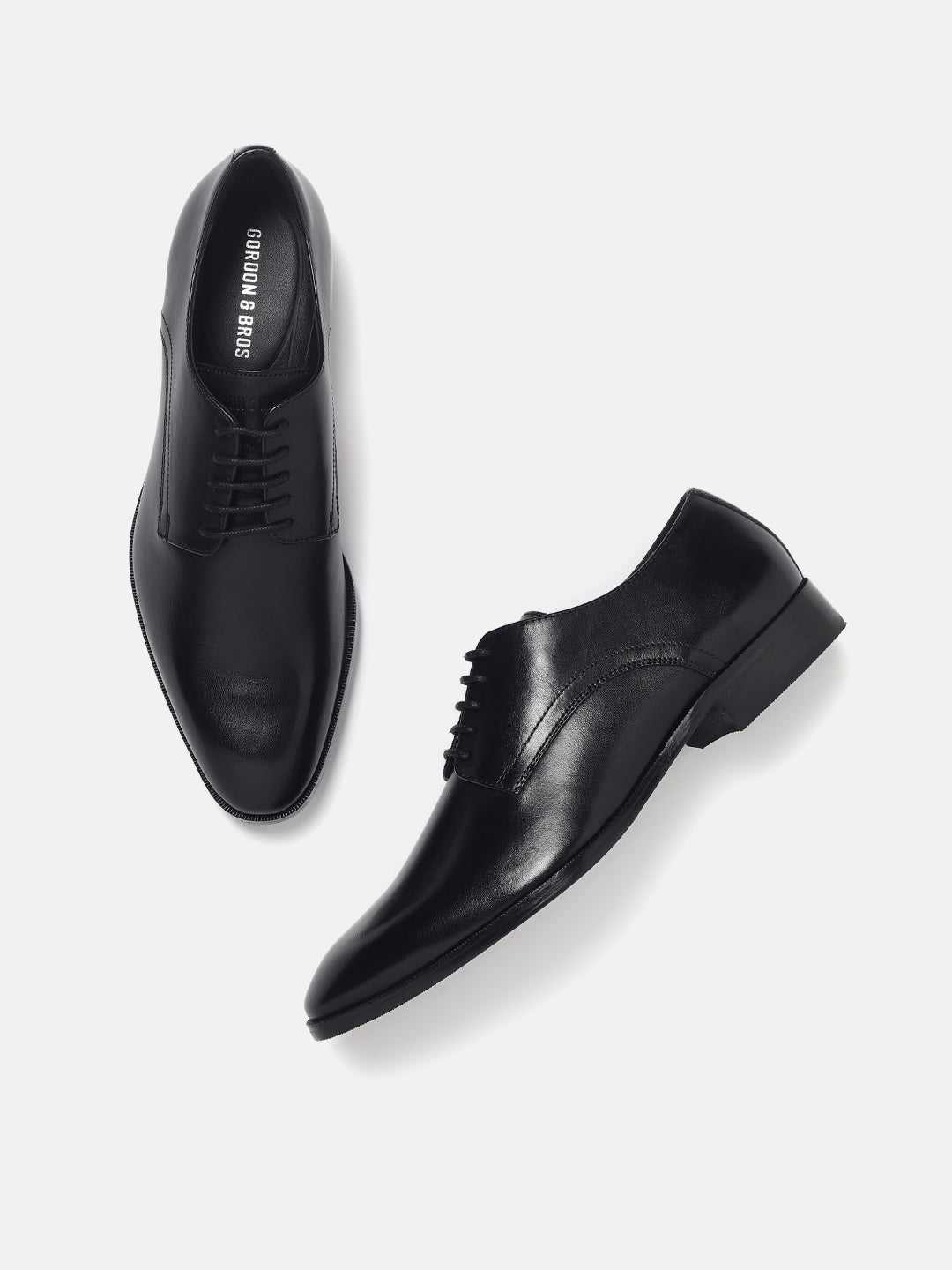 Black Derby lace-up formal shoes for men featuring a polished leather texture and elegant design — perfect for office and formal wear.