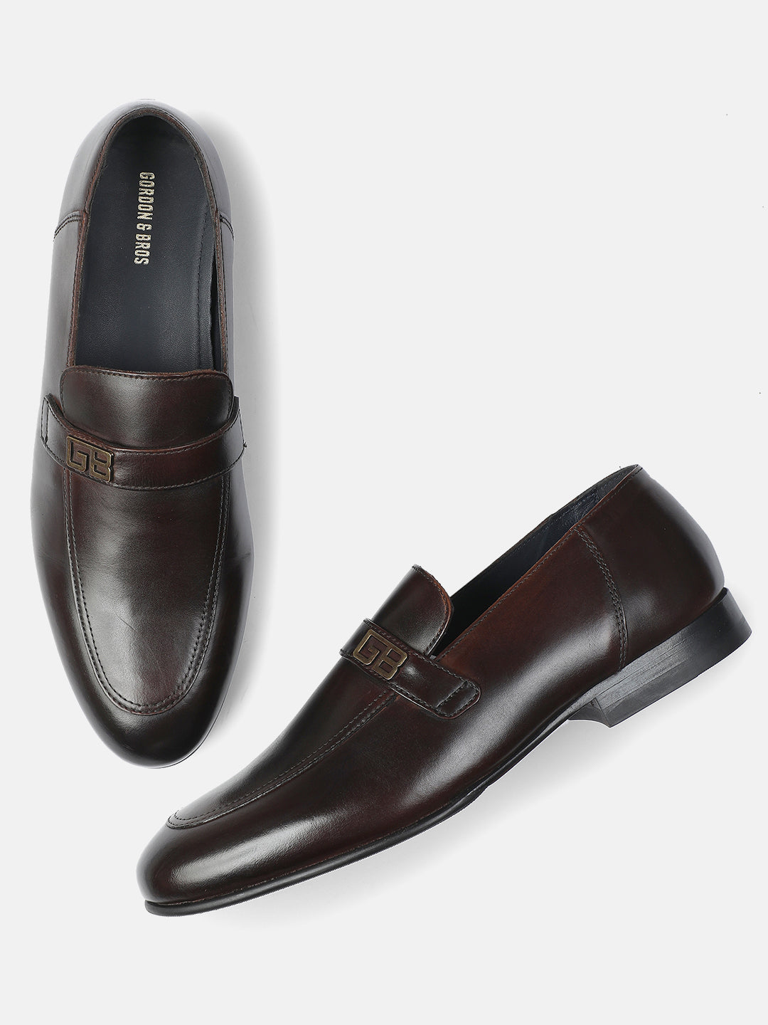 Pair of brown leather loafers on a white background