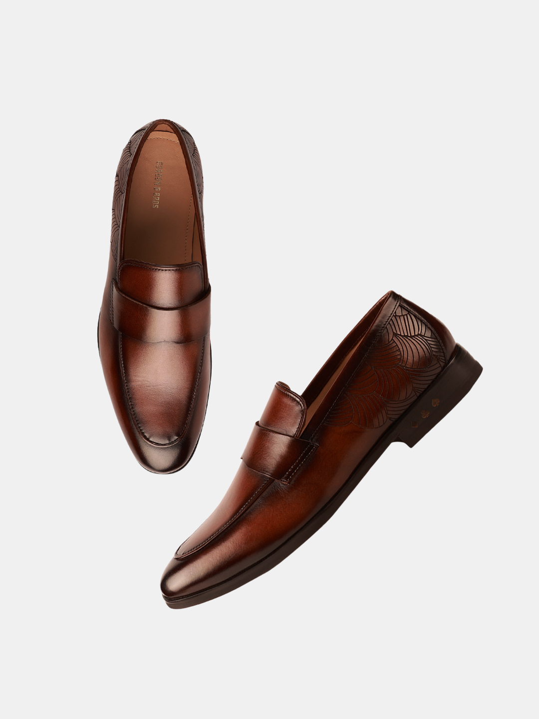 A pair of brown leather loafers isolated on a white background