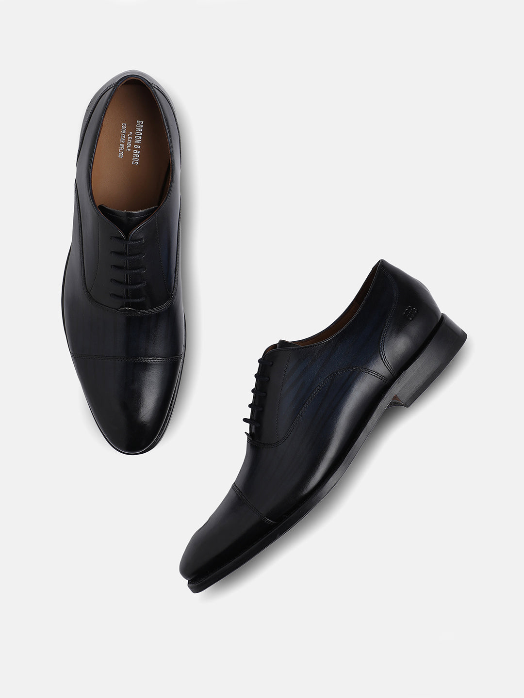 A pair of navy blue leather Oxford loafers with lace-up closures, displayed against a white background.